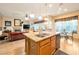Open-concept kitchen and living area with a granite-topped island and bar seating at 3615 Hardwick Hall Way, Las Vegas, NV 89135