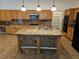 Spacious kitchen featuring an island, granite countertops, and ample cabinet space at 3615 Hardwick Hall Way, Las Vegas, NV 89135