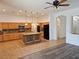 Open kitchen with granite countertops, tile flooring, and a central island at 3615 Hardwick Hall Way, Las Vegas, NV 89135