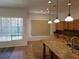 Kitchen featuring a central island, granite countertops, and a view of the pool at 3615 Hardwick Hall Way, Las Vegas, NV 89135