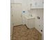 Functional laundry room with white cabinets, a utility sink, and tile flooring at 3615 Hardwick Hall Way, Las Vegas, NV 89135