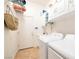 Bright laundry room featuring a washer, dryer, utility sink, and ample storage at 3615 Hardwick Hall Way, Las Vegas, NV 89135