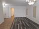 Open-concept living room with a chandelier and luxury vinyl plank flooring at 3615 Hardwick Hall Way, Las Vegas, NV 89135