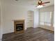 Bright living room featuring a fireplace, built-in shelves, and large windows at 3615 Hardwick Hall Way, Las Vegas, NV 89135