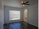 Spacious main bedroom with dark wood floors, large window, and arched access to the bathroom at 3615 Hardwick Hall Way, Las Vegas, NV 89135