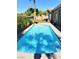 Relaxing pool with clear blue water, surrounded by lush landscaping and ample space for lounging at 3615 Hardwick Hall Way, Las Vegas, NV 89135