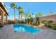 Inviting backyard swimming pool with stone pavers, lush landscaping, and a serene atmosphere at 3615 Hardwick Hall Way, Las Vegas, NV 89135