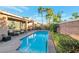 Backyard featuring a swimming pool, patio seating, and well-maintained landscaping at 3615 Hardwick Hall Way, Las Vegas, NV 89135