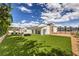 Expansive backyard featuring an artificial lawn and an oversized chess set, complemented by lounge seating at 3731 Caesars Cir, Las Vegas, NV 89120