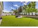 Spacious backyard featuring lush green lawn, enhanced by tasteful landscaping and a fun, oversized chess set at 3731 Caesars Cir, Las Vegas, NV 89120