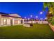 Expansive backyard features lush green artificial turf and giant chess set with outdoor lighting at 3731 Caesars Cir, Las Vegas, NV 89120