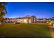Expansive backyard featuring an artificial lawn, string lights, giant chess, and covered patio at 3731 Caesars Cir, Las Vegas, NV 89120