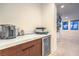 Cozy bar area with built-in beverage refrigerator, coffee maker, and views of the main bedroom at 3731 Caesars Cir, Las Vegas, NV 89120