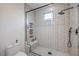 Modern shower stall featuring white subway tile, hexagon floor and sleek fixtures at 3731 Caesars Cir, Las Vegas, NV 89120