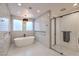 Elegant bathroom featuring a freestanding tub, subway tile walls, and glass shower at 3731 Caesars Cir, Las Vegas, NV 89120
