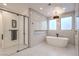 Sleek bathroom boasting modern shower with glass door, white subway tile, and hexagon floor tiles at 3731 Caesars Cir, Las Vegas, NV 89120