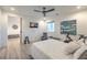 Inviting bedroom featuring a ceiling fan, ensuite workout area and wood-look flooring at 3731 Caesars Cir, Las Vegas, NV 89120