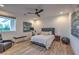 Bright bedroom featuring a ceiling fan, with ensuite workout area and wood-look flooring at 3731 Caesars Cir, Las Vegas, NV 89120