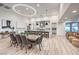 Open concept dining room and kitchen area boasts modern lighting and wood floors at 3731 Caesars Cir, Las Vegas, NV 89120