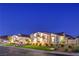 This single-story home features stucco siding, complemented by professional landscaping and lighting at 3731 Caesars Cir, Las Vegas, NV 89120