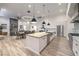 Open concept kitchen with island features stainless appliances, modern lighting, and wood floors at 3731 Caesars Cir, Las Vegas, NV 89120