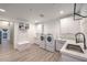Bright laundry room with modern washer and dryer, complemented by ample counter space and stylish wooden flooring at 3731 Caesars Cir, Las Vegas, NV 89120