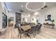 Open concept living room, dining, and kitchen area with wood floors and modern lighting at 3731 Caesars Cir, Las Vegas, NV 89120