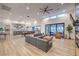 Open concept living room, dining, and kitchen area with wood floors and lots of natural light at 3731 Caesars Cir, Las Vegas, NV 89120