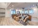 Spacious living room with plank floors, high ceilings, modern furniture, and a sliding glass door to the backyard at 3731 Caesars Cir, Las Vegas, NV 89120