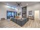 Bright living room boasts wood floors, high ceilings, fireplace, modern fan, and access to outdoor space at 3731 Caesars Cir, Las Vegas, NV 89120