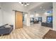 Open-concept living area with modern lighting, wood flooring, and an elegant barn door at 3731 Caesars Cir, Las Vegas, NV 89120