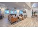 Open concept living room with wood floors, comfortable seating, pool table, and large windows for natural light at 3731 Caesars Cir, Las Vegas, NV 89120