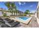 Stunning backyard featuring a pristine pool with in-pool loungers and ample space for sunbathing at 3731 Caesars Cir, Las Vegas, NV 89120