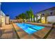 Stunning swimming pool and spa with modern design, surrounded by lush landscaping for ultimate relaxation and privacy at 3731 Caesars Cir, Las Vegas, NV 89120