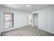 Carpeted bedroom with a view from the window and a closet with plain doors at 3790 Shirebrook Dr # 167, Las Vegas, NV 89115