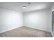 Clean carpeted bedroom featuring a plain light fixture with a window and door at 3790 Shirebrook Dr # 167, Las Vegas, NV 89115