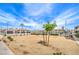 Common area with sparse landscaping and tennis courts behind the fence under a sunny blue sky at 3790 Shirebrook Dr # 167, Las Vegas, NV 89115
