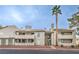Multi-level building exterior with tan stucco, balconies, and mature landscaping at 3790 Shirebrook Dr # 167, Las Vegas, NV 89115
