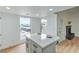 Bright kitchen featuring a large island, white cabinetry, and modern design elements with lots of natural light at 3790 Shirebrook Dr # 167, Las Vegas, NV 89115