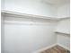 Walk-in closet featuring simple shelving and laminate flooring with a clean, minimalist design at 3790 Shirebrook Dr # 167, Las Vegas, NV 89115