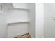 Walk-in closet featuring simple shelving and laminate flooring with a clean, minimalist design at 3790 Shirebrook Dr # 167, Las Vegas, NV 89115