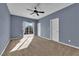 Bedroom features plush carpet, ceiling fan, and sliding glass doors at 4063 Lower Saxon Ave, North Las Vegas, NV 89085