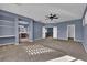 Open bonus room with neutral carpet, ceiling fan, and natural light at 4063 Lower Saxon Ave, North Las Vegas, NV 89085