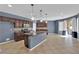 Open kitchen featuring a center island, tiled backsplash, stainless steel appliances, and sliding glass doors at 4063 Lower Saxon Ave, North Las Vegas, NV 89085