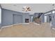 Open living room with fireplace, tile floors, and staircase at 4063 Lower Saxon Ave, North Las Vegas, NV 89085