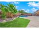 Backyard with pool, synthetic grass, and tall privacy wall at 4063 Lower Saxon Ave, North Las Vegas, NV 89085