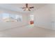 Spacious bedroom featuring a ceiling fan, plush carpeting, and a bathroom entrance at 4740 Killington St, Las Vegas, NV 89129