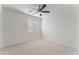 Bright bedroom features neutral carpet, a ceiling fan, and natural light from the window at 4740 Killington St, Las Vegas, NV 89129