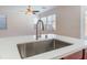 Spacious kitchen island with stainless steel sink and modern faucet fixtures at 4740 Killington St, Las Vegas, NV 89129