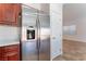 Kitchen with stainless steel refrigerator and tile floors leading to dining area at 4740 Killington St, Las Vegas, NV 89129